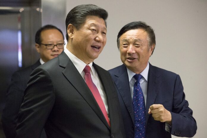 Chinese President Xi Jinping pauses as he is shown around the offices of Huawei Technologies Co Ltd by Ren Zhengfei, president of Huawei, in London