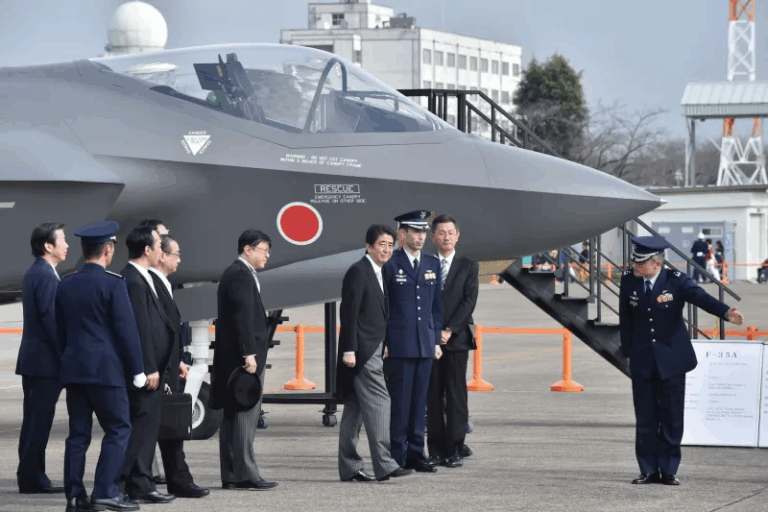 Japanese Prime Minister Shinzo Abe (C) leaves after an inspection of a mock-up F35A fighter during a review ceremony at the Japan Air Self-Defense Force's Hyakuri air base Ibaraki prefecture on Oct. 26, 2014. (KAZUHIRO NOGI/AFP/Getty Images)